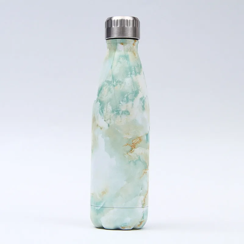 500ml stainless steel vacuum insulated sport bottle with lid on a gym bench