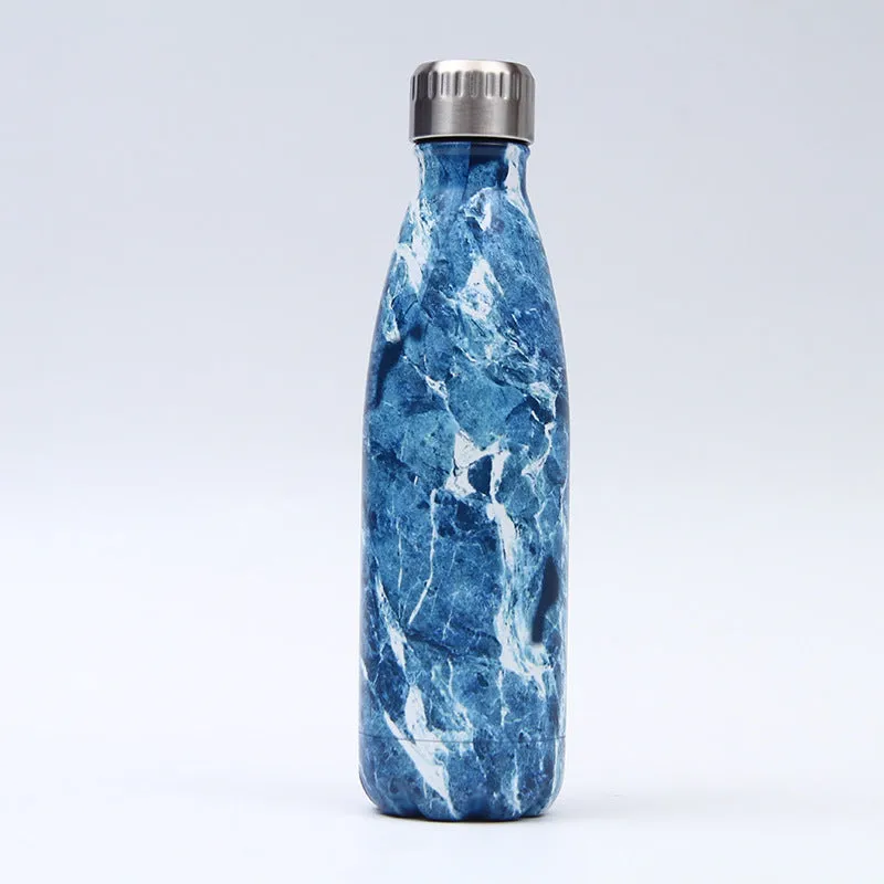 500ml stainless steel vacuum insulated sport bottle with lid on a gym bench
