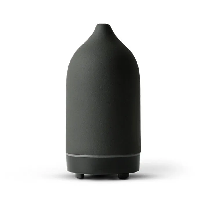 Ceramic aroma diffuser humidifier with 160ml tank, white ceramic finish, single mist outlet, on a wooden table.
