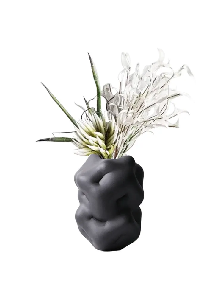Ceramic flower vase with irregular concave-convex surface in white, 26x25x34cm, on a wooden table