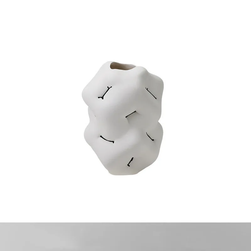 Ceramic flower vase with irregular concave-convex surface in white, 26x25x34cm, on a wooden table