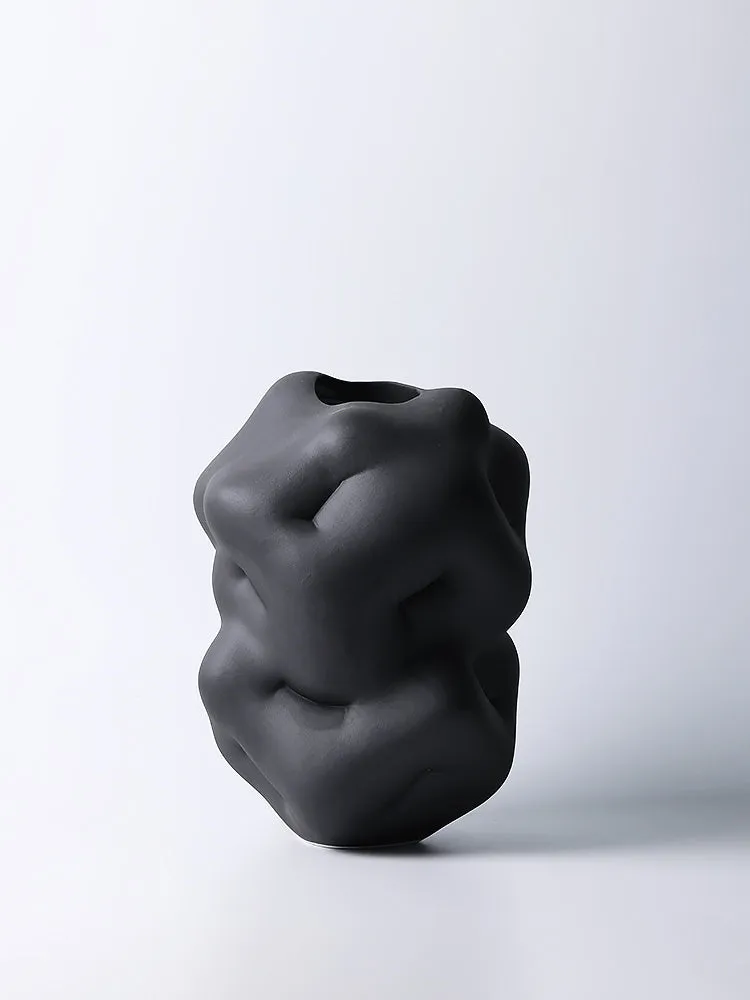 Ceramic flower vase with irregular concave-convex surface in white, 26x25x34cm, on a wooden table
