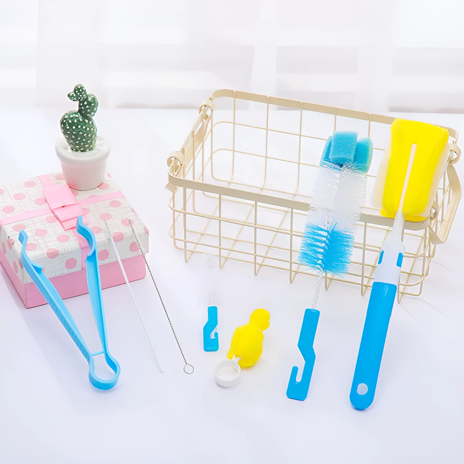 Orange Belle seven-piece bottle brush set in blue and pink includes sponge brush, nylon brush, nipple brushes, straw brushes, and bottle holder