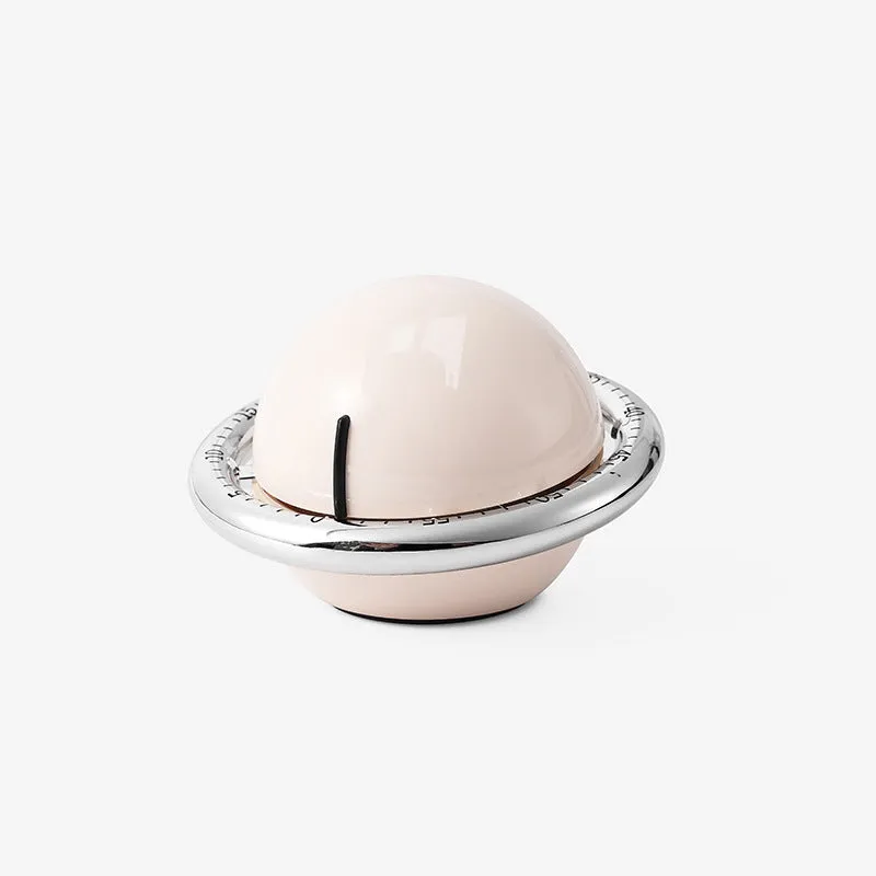 Beige mechanical kitchen timer with manual twist dial and countdown display on a kitchen countertop