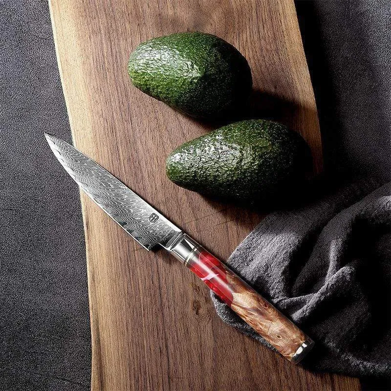 Damascus chef's knife with unique epoxy resin handle and Three German steel blade on cutting board