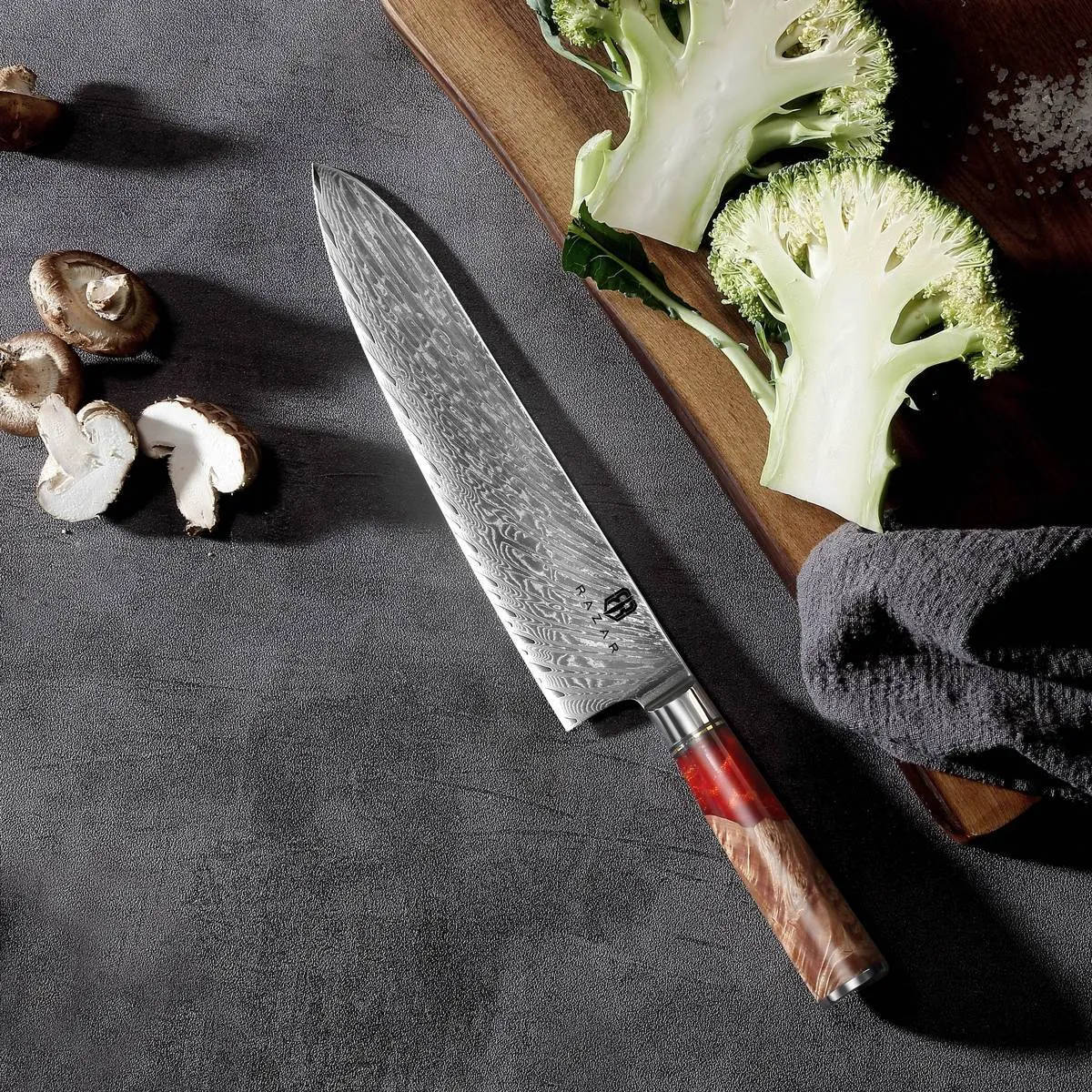 Damascus chef's knife with unique epoxy resin handle and Three German steel blade on cutting board