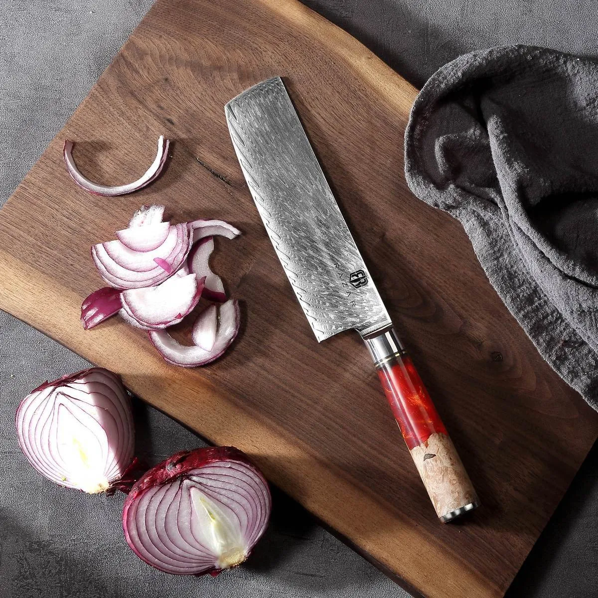 Damascus chef's knife with unique epoxy resin handle and Three German steel blade on cutting board