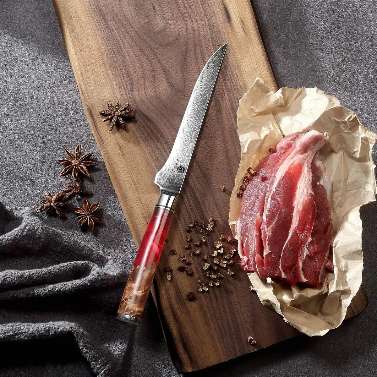 Damascus chef's knife with unique epoxy resin handle and Three German steel blade on cutting board