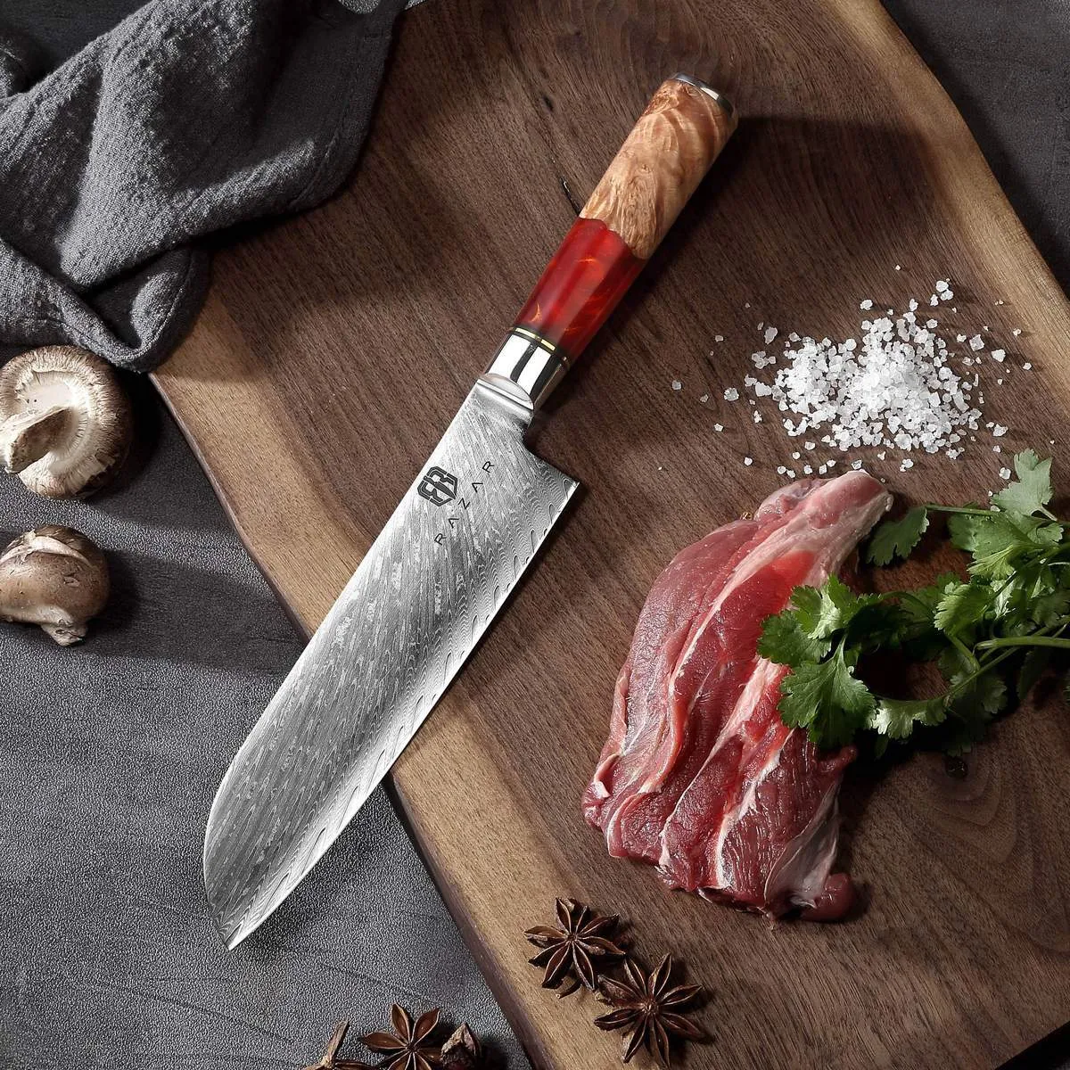 Damascus chef's knife with unique epoxy resin handle and Three German steel blade on cutting board