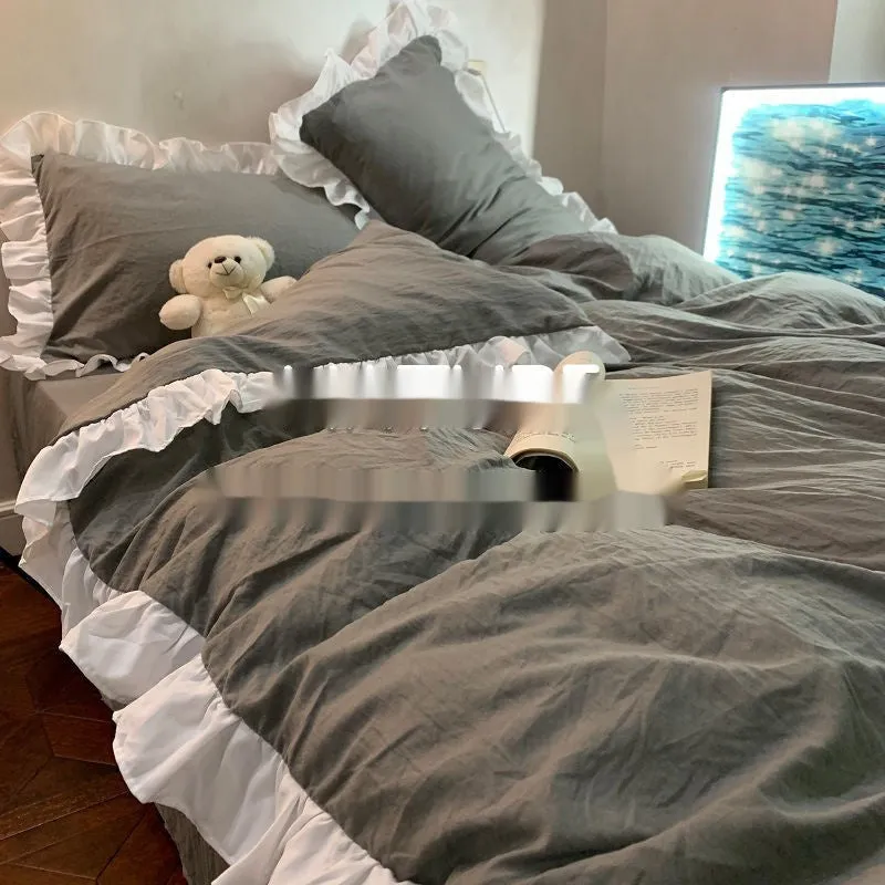 Washed cotton linen four-piece bedding set in a solid colour, shown on a bed with quilt cover and matching pillowcases.
