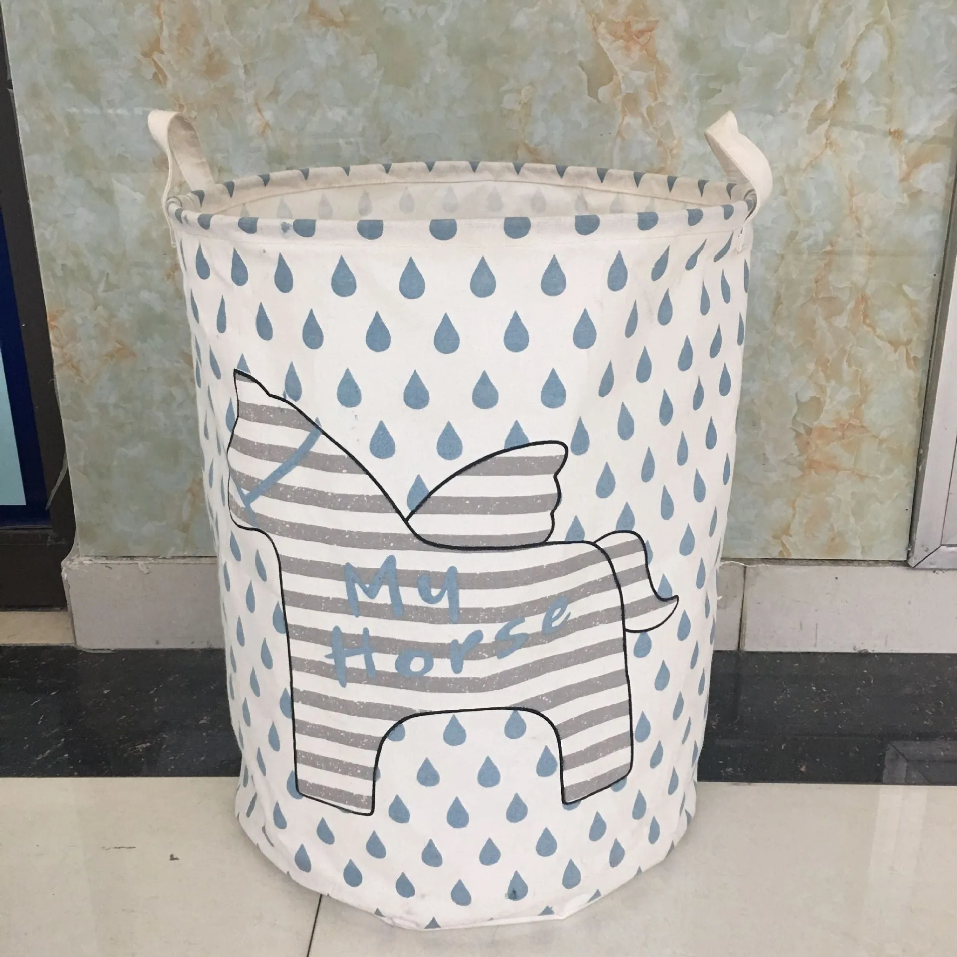 Cotton linen storage bucket with five-pointed star and horse design in a home setting
