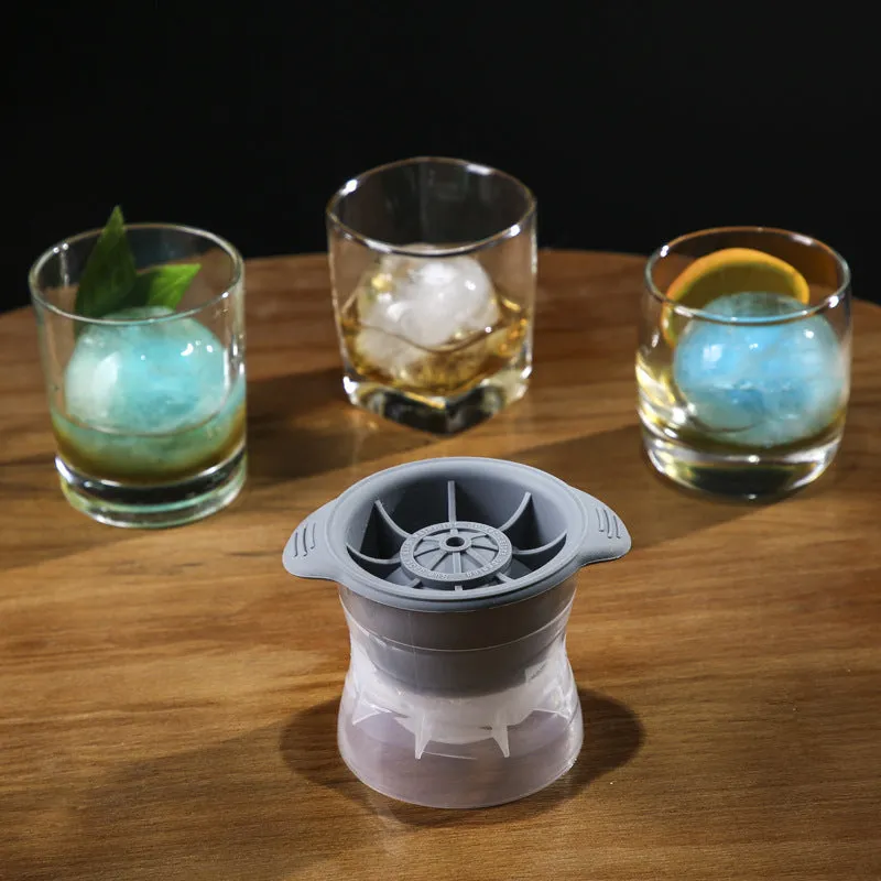 Gray silicone spherical ice ball mould with ABS lid on a kitchen countertop