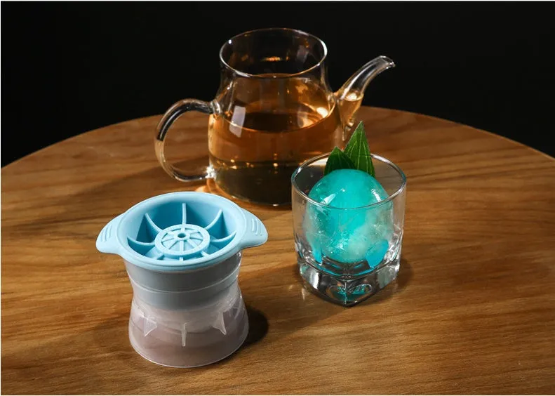 Gray silicone spherical ice ball mould with ABS lid on a kitchen countertop