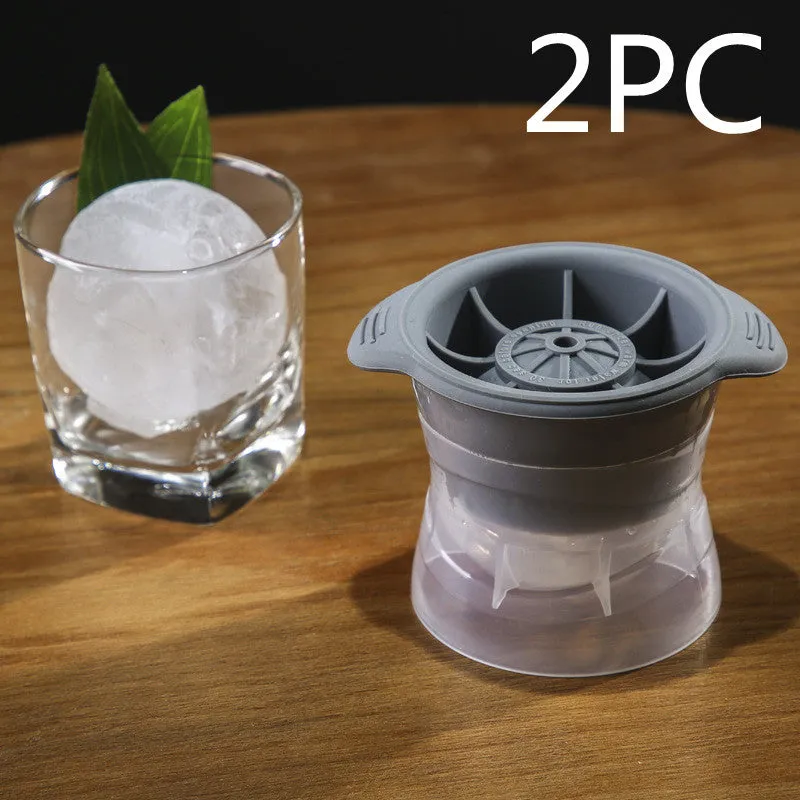 Gray silicone spherical ice ball mould with ABS lid on a kitchen countertop