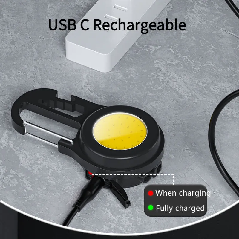 Black 6-in-1 multi-functional mini keychain lamp with COB light and magnetic base on metal surface