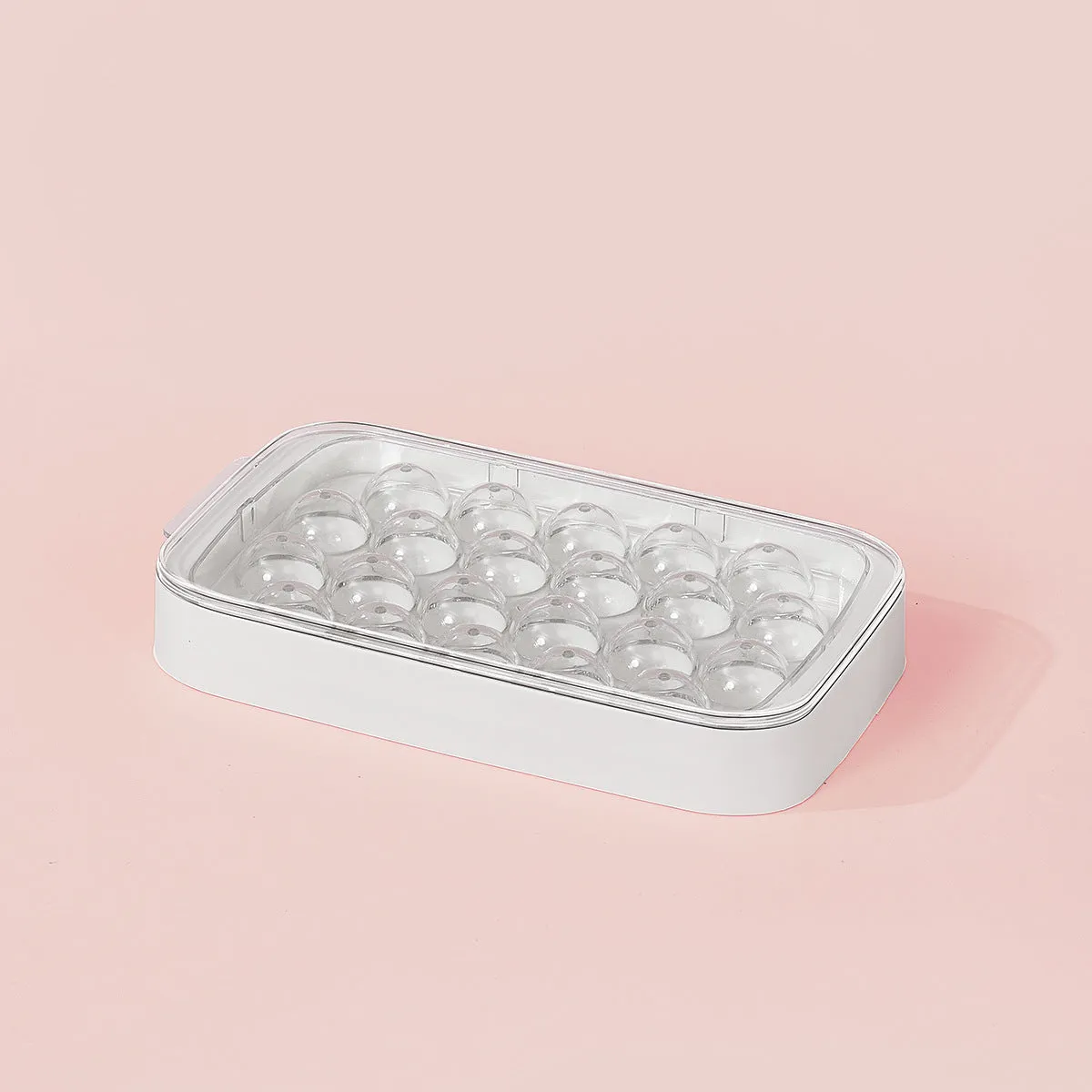 Silicone ball ice hockey mold in ivory white on a countertop, showing round cavity shapes for large ice cubes