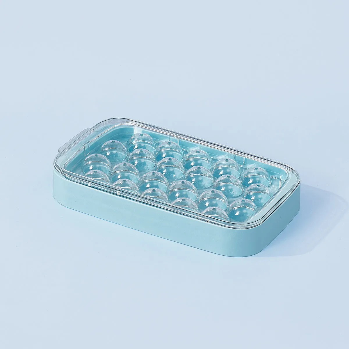 Silicone ball ice hockey mold in ivory white on a countertop, showing round cavity shapes for large ice cubes