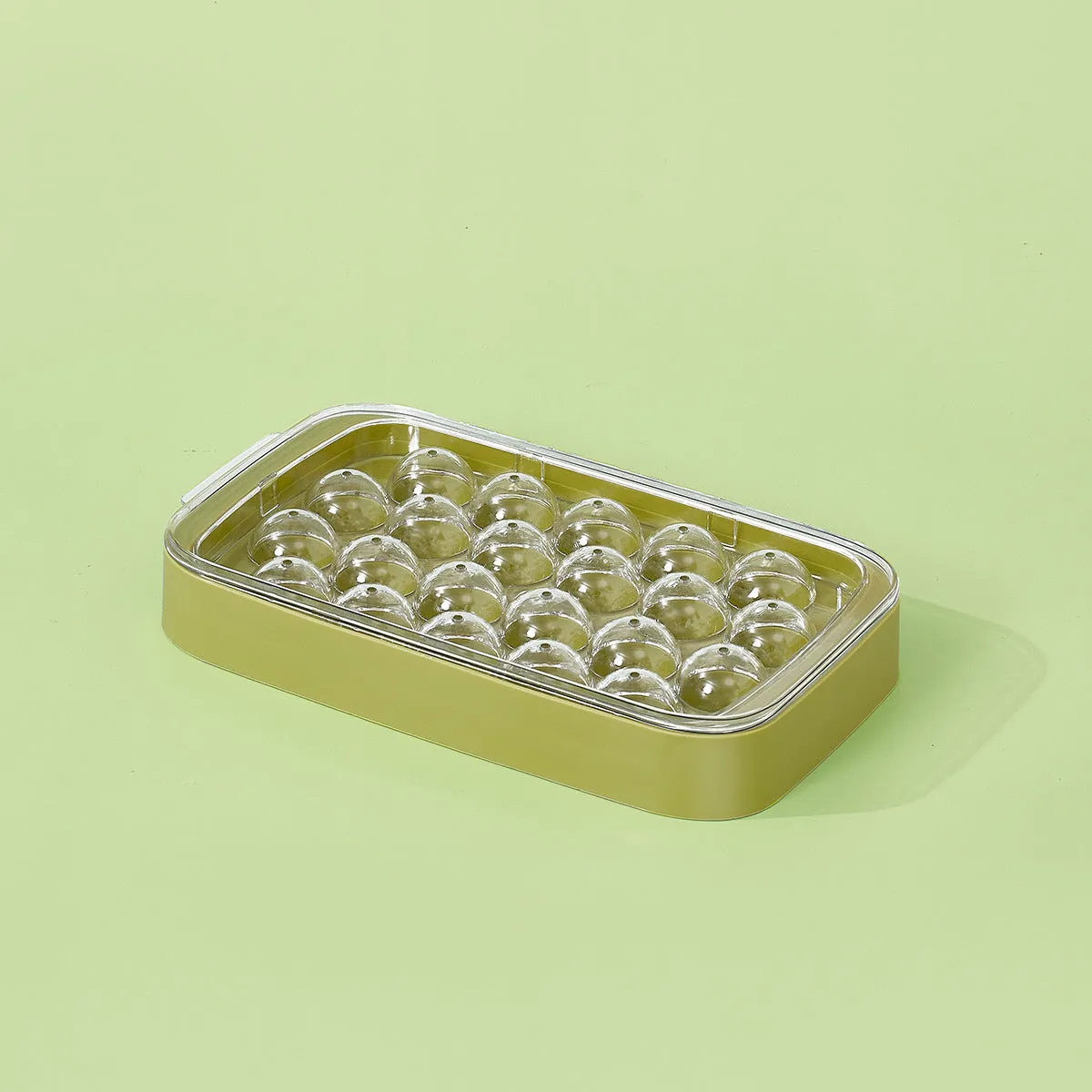 Silicone ball ice hockey mold in ivory white on a countertop, showing round cavity shapes for large ice cubes
