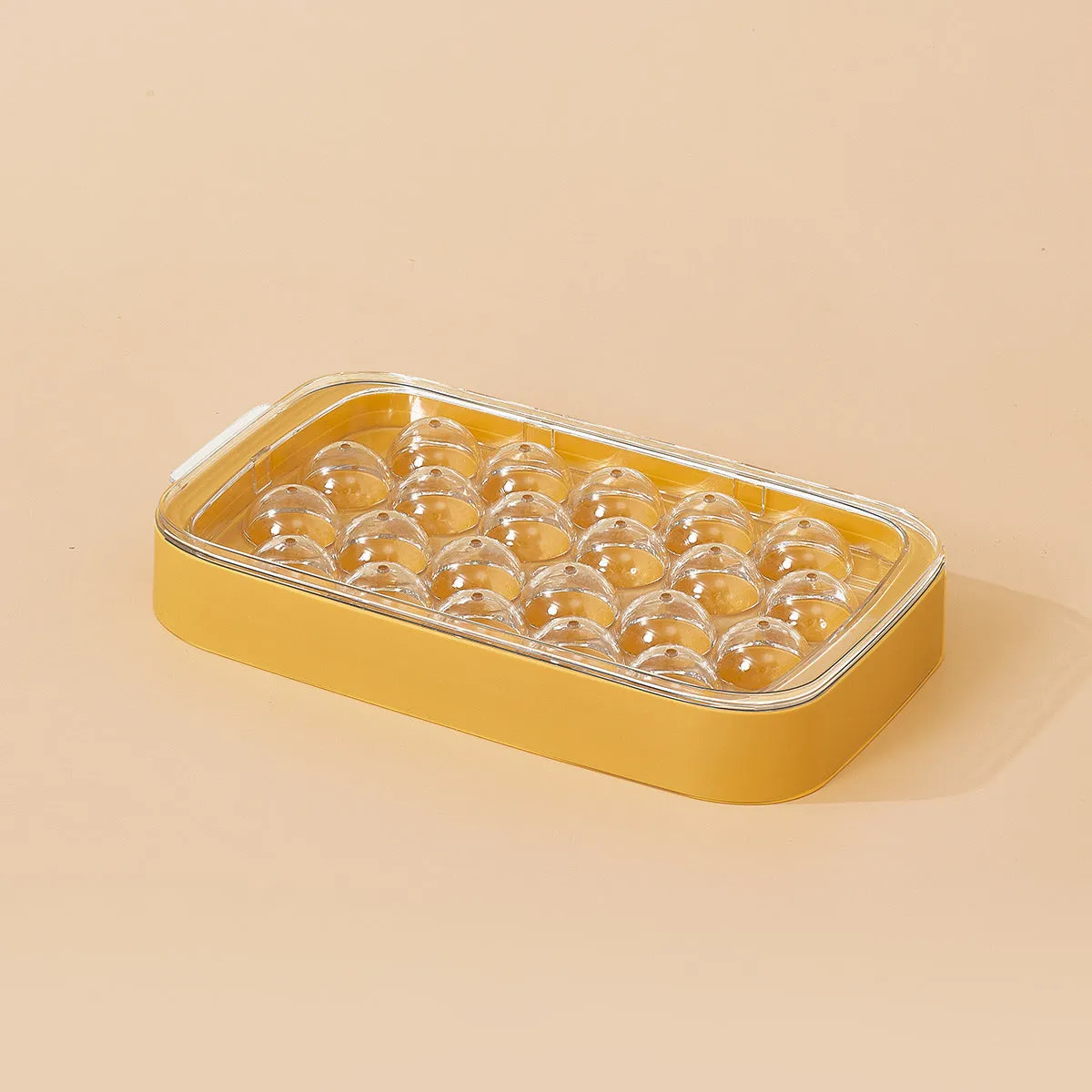 Silicone ball ice hockey mold in ivory white on a countertop, showing round cavity shapes for large ice cubes
