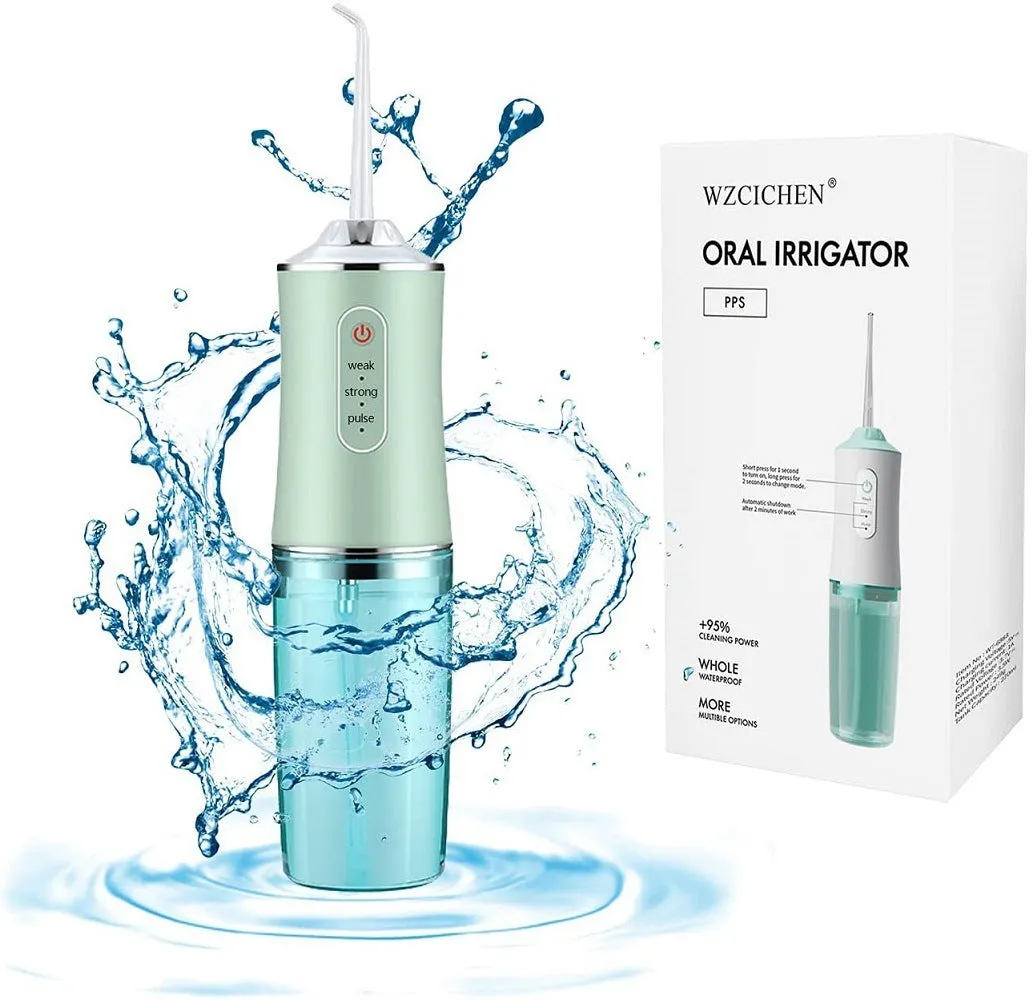 White portable oral irrigator with four nozzles and USB charging cable on a bathroom surface