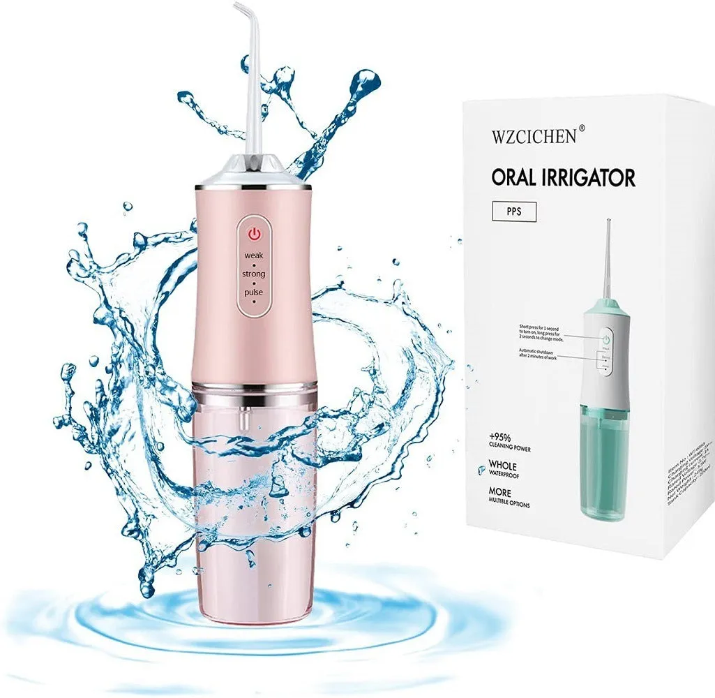 White portable oral irrigator with four nozzles and USB charging cable on a bathroom surface