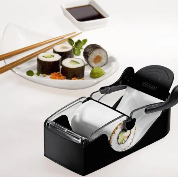 Black DIY plastic kitchen roll sushi machine on a flat surface with lever and roller band visible