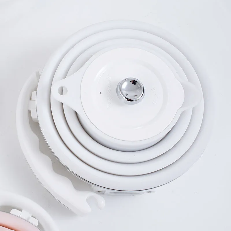 Foldable electric kettle in collapsed position showing compact 50mm height, silicone body, and power cord