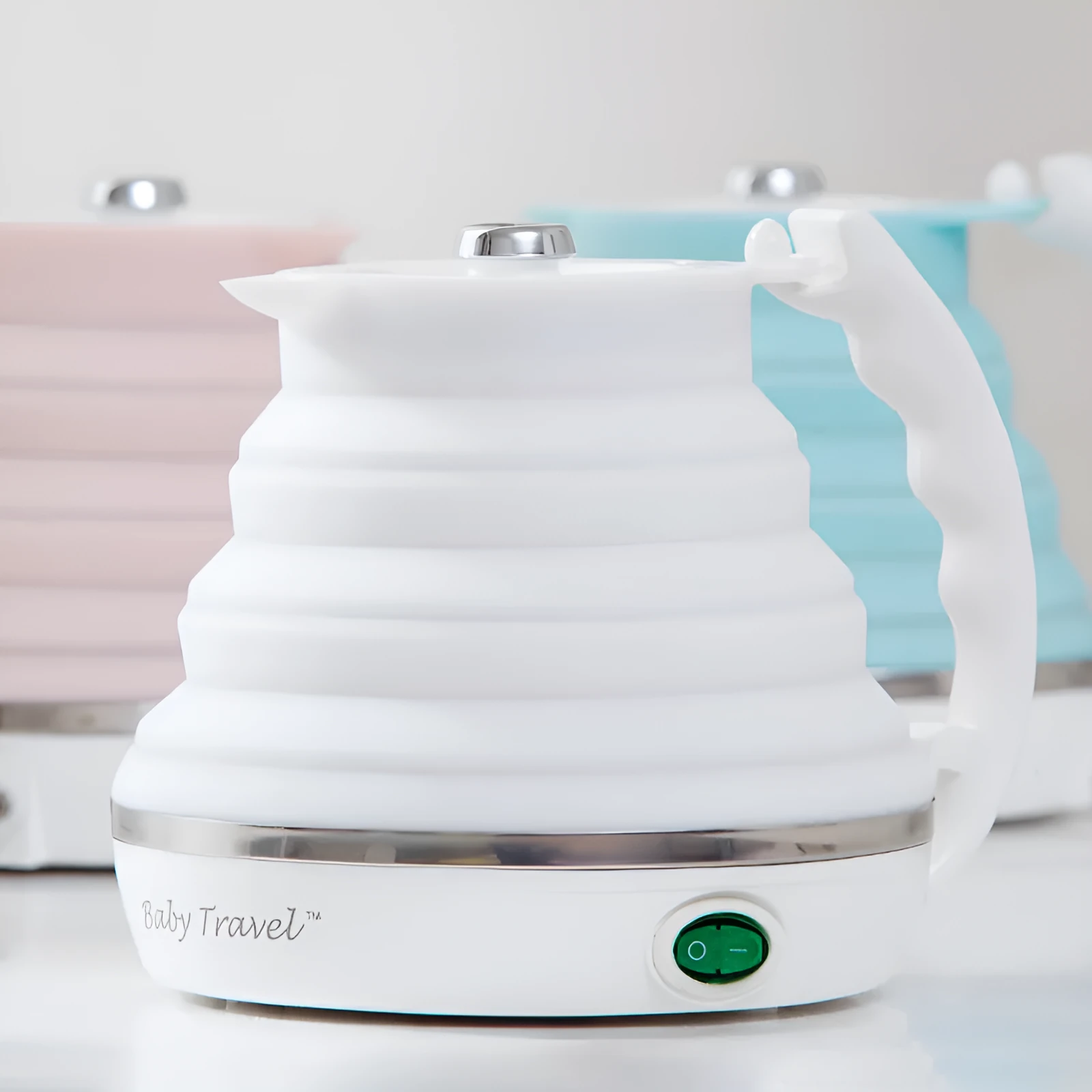 Foldable electric kettle in collapsed position showing compact 50mm height, silicone body, and power cord
