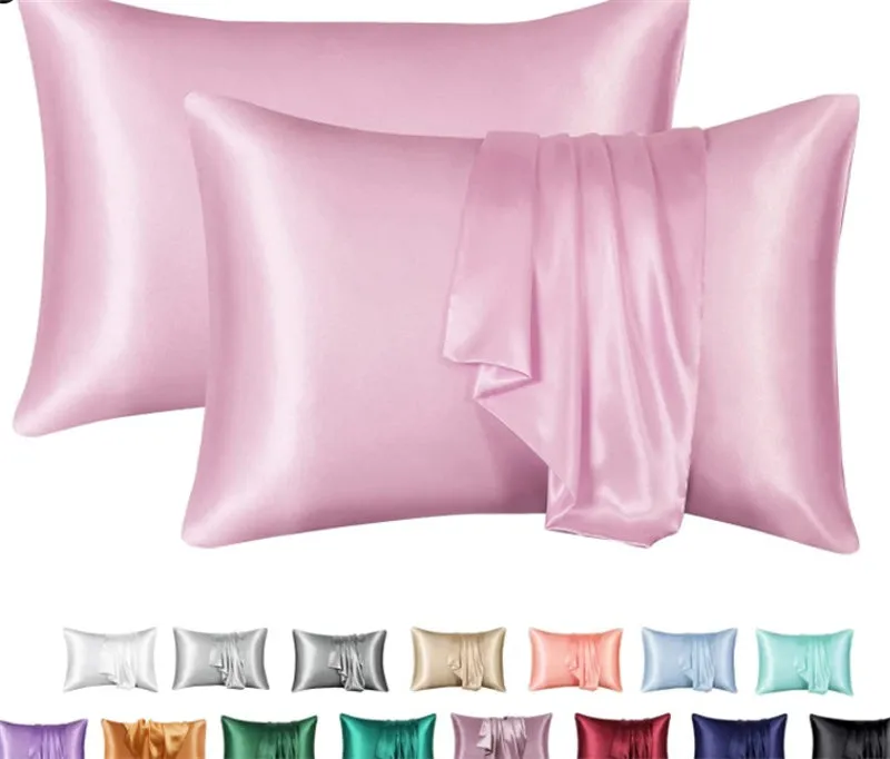 Dark blue polyester satin pillowcase with envelope closure on a bed with white sheets