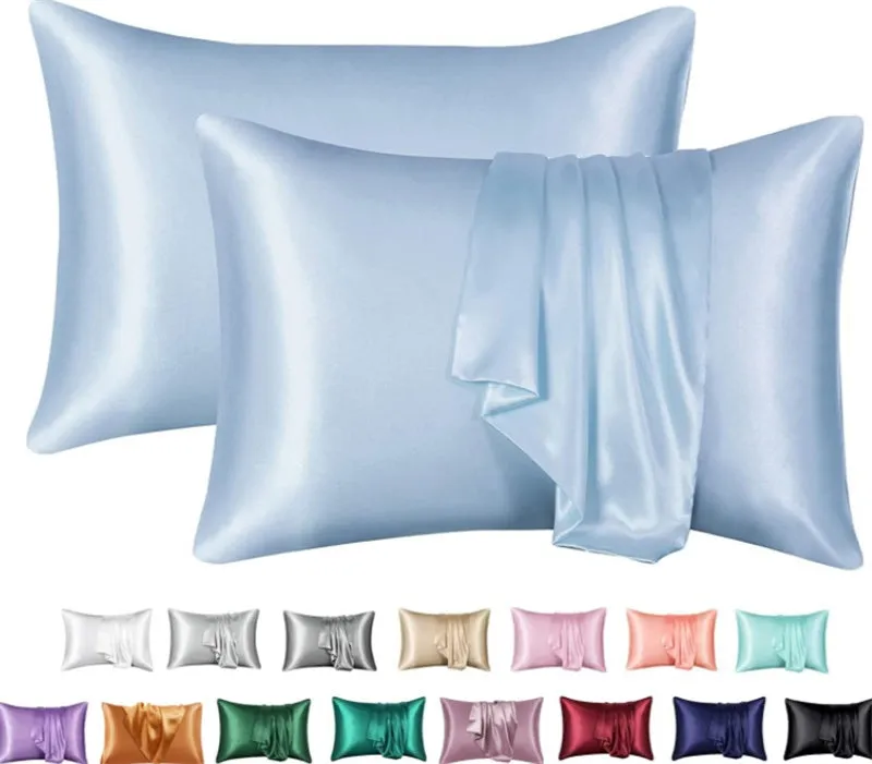 Dark blue polyester satin pillowcase with envelope closure on a bed with white sheets