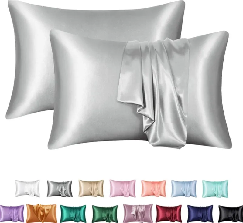 Dark blue polyester satin pillowcase with envelope closure on a bed with white sheets