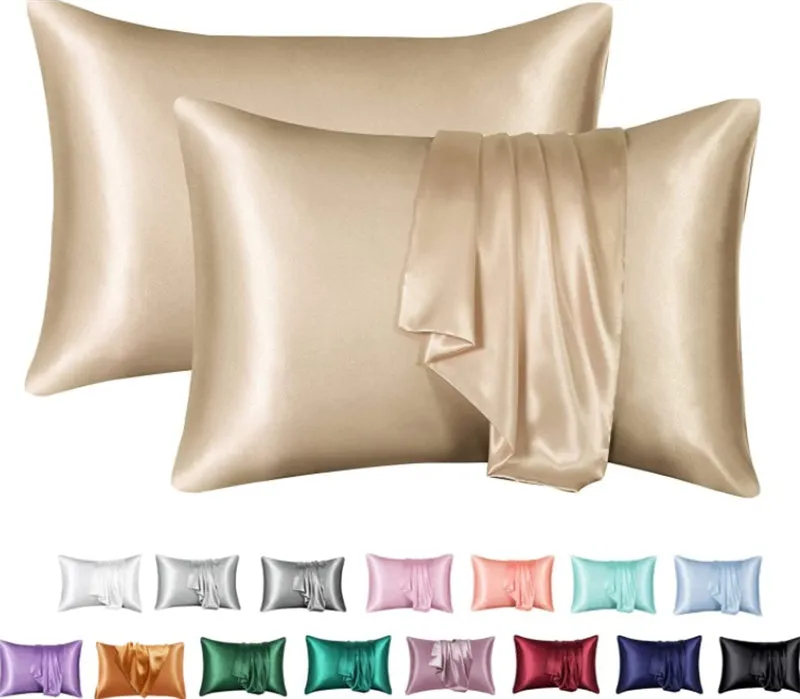 Dark blue polyester satin pillowcase with envelope closure on a bed with white sheets