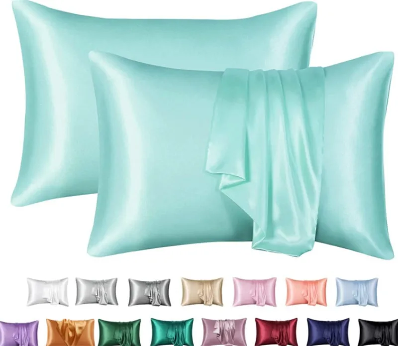 Dark blue polyester satin pillowcase with envelope closure on a bed with white sheets