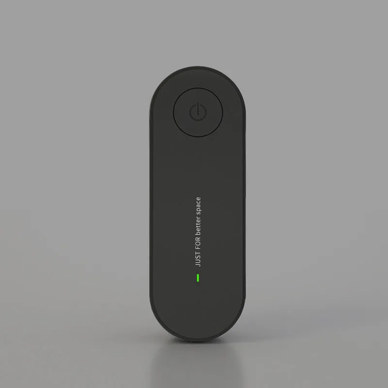 Small negative ion air purifier in black, plugged into a wall socket, with a room in the background