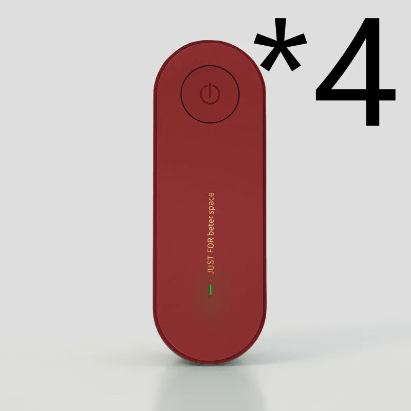 Small negative ion air purifier in black, plugged into a wall socket, with a room in the background