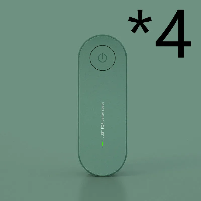Small negative ion air purifier in black, plugged into a wall socket, with a room in the background