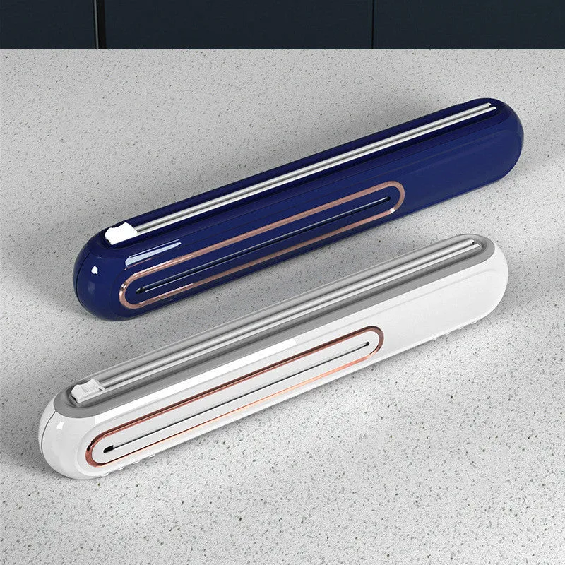 White and blue magnetic cling film cutter hanging on a fridge with a film roll