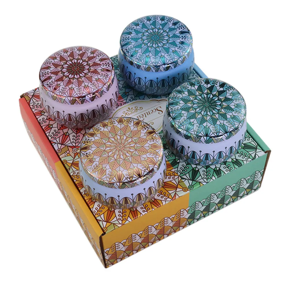 Set of four soy wax scented candles with dried flowers in cylindrical shape, 125g each, on a table