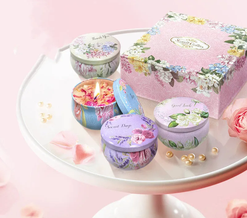 Set of four soy wax scented candles with dried flowers in cylindrical shape, 125g each, on a table