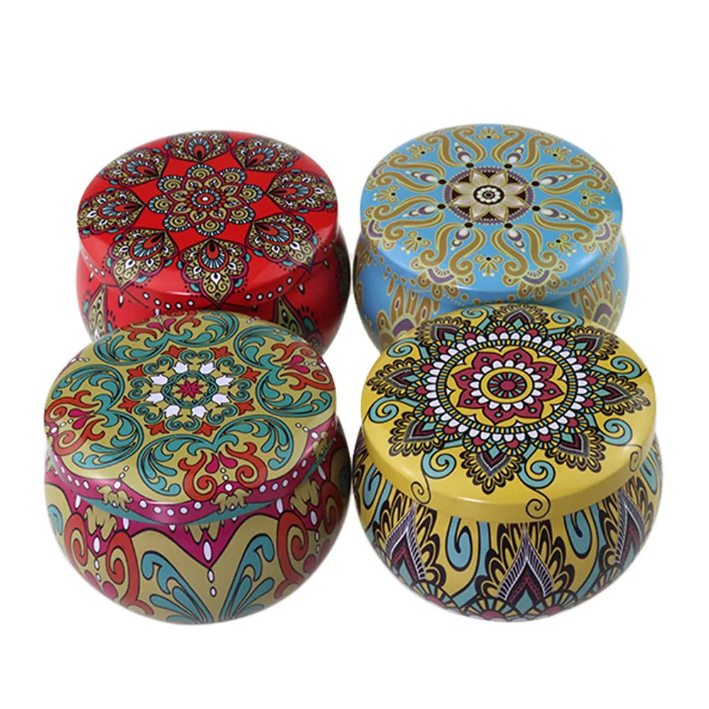 Set of four soy wax scented candles with dried flowers in cylindrical shape, 125g each, on a table