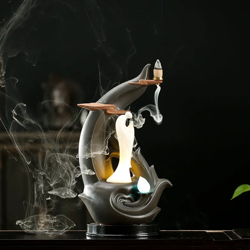 Purple sand tea pet with backflow incense and LED light in Jinglian Tianxiang style on a wooden table