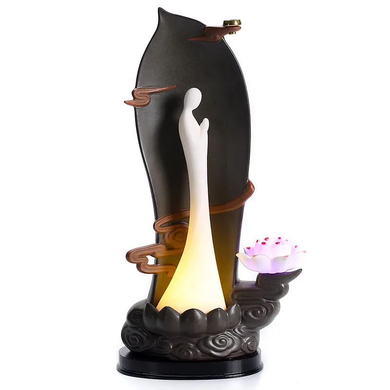 Purple sand tea pet with backflow incense and LED light in Jinglian Tianxiang style on a wooden table