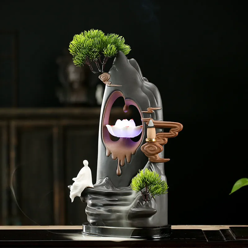 Purple sand tea pet with backflow incense and LED light in Jinglian Tianxiang style on a wooden table