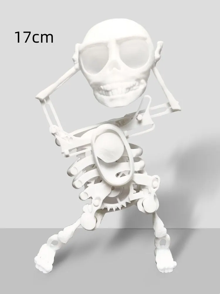 3D printed dancing skeleton gravity toy in pink and white, 22cm tall, on a desk
