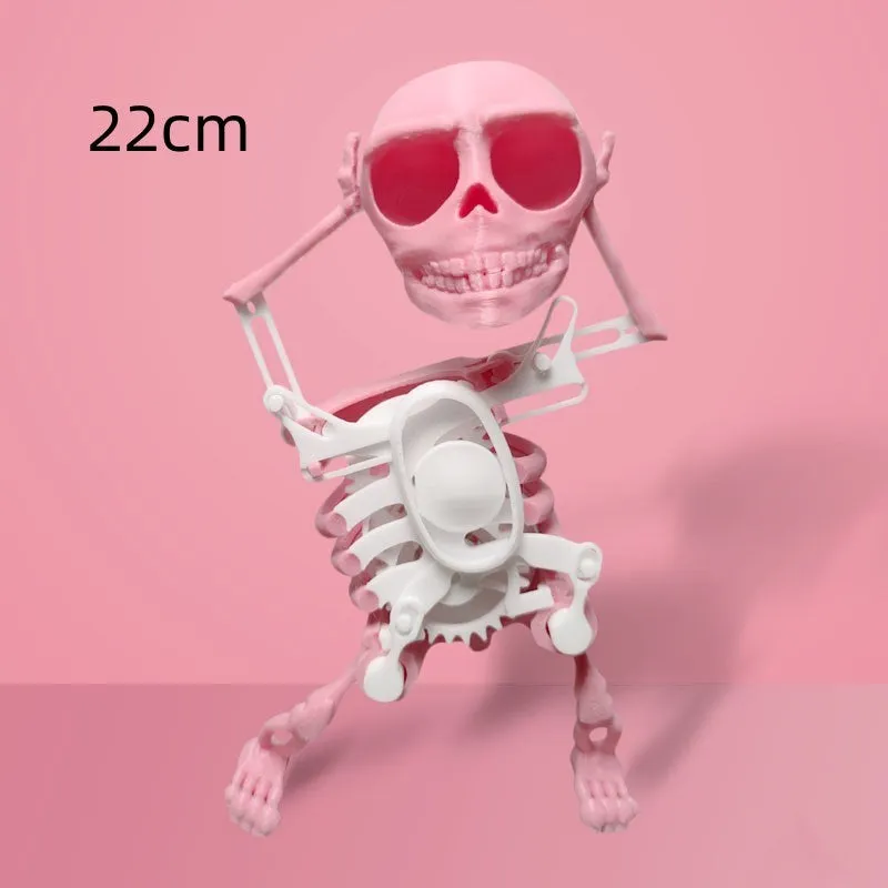3D printed dancing skeleton gravity toy in pink and white, 22cm tall, on a desk