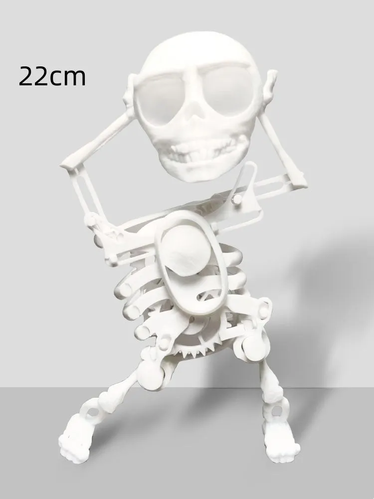 3D printed dancing skeleton gravity toy in pink and white, 22cm tall, on a desk