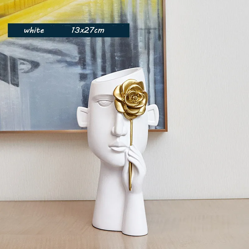 Modern black and white resin vase with sculpted body shape on living room table