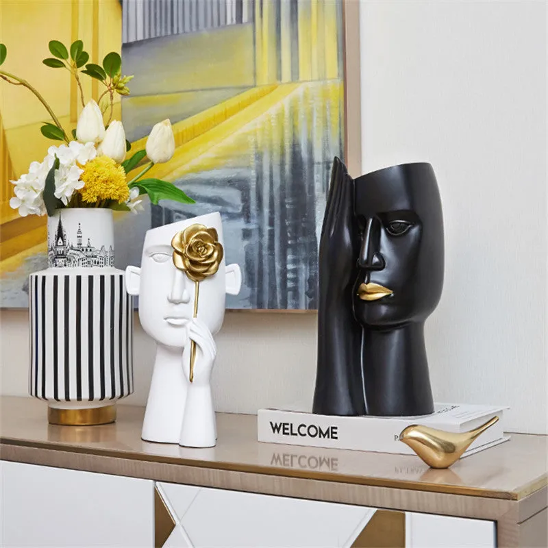 Modern black and white resin vase with sculpted body shape on living room table