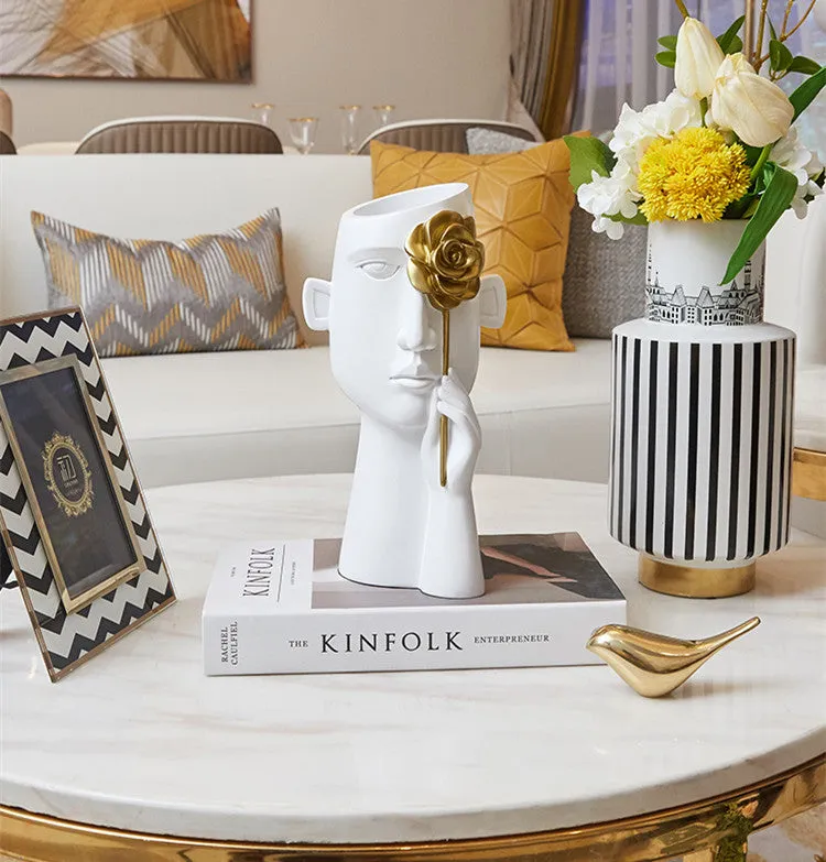 Modern black and white resin vase with sculpted body shape on living room table