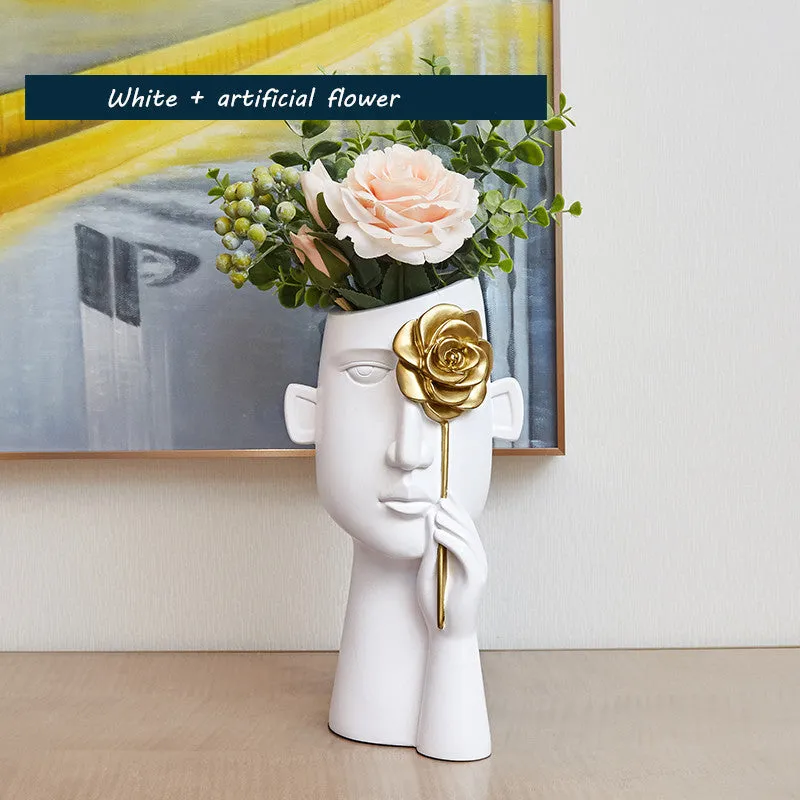 Modern black and white resin vase with sculpted body shape on living room table